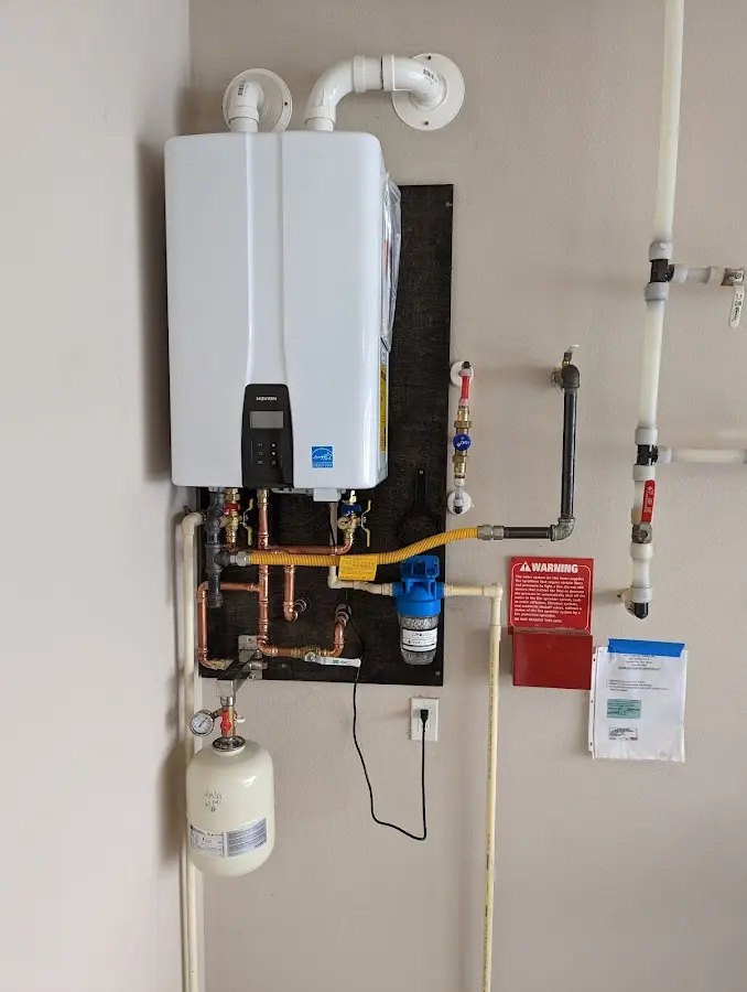 Professional plumber installing copper piping in a St. Paul home